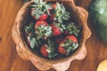 Strawberries in a wooden teak bowl. Indonesian teak bowl.