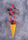 Strawberriess in waffle yellow cone on a concreate background. Royalty Free Stock Photo