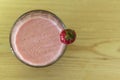 Top view of galss with Strawberry juice on wooden background