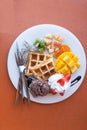 strawberry apple mango orange kiwi waffle with chocolate ice cream and whip cream Royalty Free Stock Photo