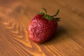 Strawberry on the background of a beautiful lacquered wood close-up