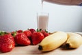 Strawberry banana smoothie fresh blended on wood table Royalty Free Stock Photo