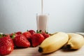 Strawberry banana smoothie fresh blended on wood table Royalty Free Stock Photo