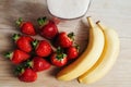 Strawberry banana smoothie fresh blended on wood table