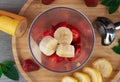 Strawberry and banana smoothie in a glass bowl on wooden table Royalty Free Stock Photo