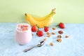 Strawberry and banana smoothies with berries and banana on a bright table. Useful breakfast made with ingredients. Healthy and Royalty Free Stock Photo