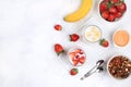 Strawberry and banana smoothies with berries and banana on a bright table. Useful breakfast made with ingredients. Healthy and Royalty Free Stock Photo