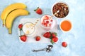 Strawberry and banana smoothies with berries and banana on a bright table. Useful breakfast made with ingredients. Healthy and Royalty Free Stock Photo