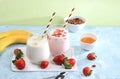 Strawberry and banana smoothies, yogurt with berries and honey on a bright table.Useful breakfast with ingredients. Healthy and Royalty Free Stock Photo