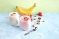 Strawberry and banana smoothies, yogurt with berries and honey on a bright table.Useful breakfast with ingredients. Healthy and Royalty Free Stock Photo