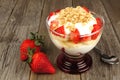 Strawberry banana yogurt parfait on wood