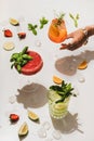 Strawberry basil Margarita, Gin-tonic and Aperol Spritz cicktail in hand Royalty Free Stock Photo