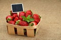 Strawberry in basket with price sign on canvas