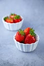 Strawberry berries in a white bowl on a concrete table. Place for text. Strawberries in a plate - dessert. Healthy food. Royalty Free Stock Photo