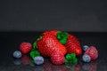 Strawberry on black background blueberry raspberry Royalty Free Stock Photo