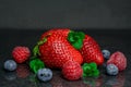 Strawberry on black background blueberry raspberry Royalty Free Stock Photo