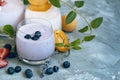 Strawberry, blueberry, apricot smoothie on light background decorated with leaves. with fresh berries milkshake. well being weight Royalty Free Stock Photo