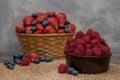 Strawberry and blueberry in basket and raspberries in bowl on wood table. Fresh berries. Royalty Free Stock Photo