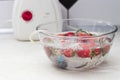 strawberry in a bowl with water with a round ozonating stone. Tubes leading to oxygen pump and ozone generator