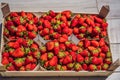 Strawberry box placed on a wooden table, healthy living concept Royalty Free Stock Photo