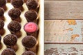Strawberry Brigadeiro Bicho de pe surrounded by traditional brigadeiros. Lined up on a golden tray, with copy space