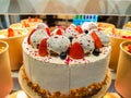 Strawberry cake on showcase, delicious cake and pastries in a glass display case. Front view Royalty Free Stock Photo