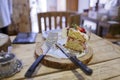 Strawberry cake on wooden table with knife, fork
