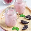 Strawberry cheesecake smoothie with cream cheese and milk, served with chocolate cookies, square format Royalty Free Stock Photo