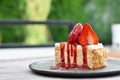 Strawberry cheesecake with strawberry slices on a gray ceramic plate. Royalty Free Stock Photo