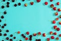 Strawberry and cherries on a blue background Royalty Free Stock Photo