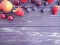 Strawberry, cherry, blueberry, frame harvest apricot on a wooden background