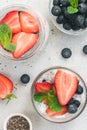 Strawberry chia pudding with fresh blueberries and mint in glass. Top view