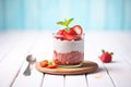 strawberry chia pudding with sliced strawberries, mint leaf