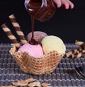 Strawberry chocolate ice cream and shortbread with falling chocolate syrup Royalty Free Stock Photo