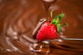 Strawberry in chocolate. Melted chocolate pouring on fresh ripe juicy strawberry closeup over swirl brown background. Fondue