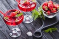 strawberry cocktail with ice and fresh mint on a black wooden table Royalty Free Stock Photo