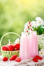Strawberry cocktail or milkshake in a jar, basket with strawberries on a picnic, healthy food for Breakfast and snacks Royalty Free Stock Photo