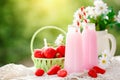 Strawberry cocktail or milkshake in a jar, basket with strawberries on a picnic, healthy food for Breakfast and snacks Royalty Free Stock Photo