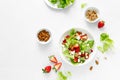 Strawberry and cottage cheese fresh fruit salad with walnut, almond and lettuce, top down view, flat lay Royalty Free Stock Photo