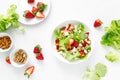 Strawberry and cottage cheese fresh fruit salad with walnut, almond and lettuce, top down view, flat lay Royalty Free Stock Photo