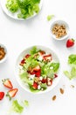 Strawberry and cottage cheese fresh fruit salad with walnut, almond and lettuce, top down view, flat lay Royalty Free Stock Photo