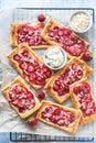 Strawberry, cream cheese and almond puff pastry pies on baking paper. Top view Royalty Free Stock Photo