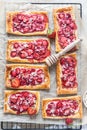 Strawberry, cream cheese and almond puff pastry pies on baking paper. Top view Royalty Free Stock Photo