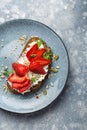 Strawberry cream cheese sandwich garnished with arugula