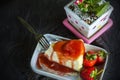 Strawberry crepe cake, topping fruits and pouring strawberry jam on ceramic plate on wood table Royalty Free Stock Photo