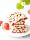 strawberry crumb bars with fresh red berries in a cup and strawberry buch with flowers on grey background Royalty Free Stock Photo