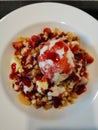 Strawberry crumble topped on pancake and vanila ice-cream