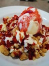 Strawberry crumble topped on pancake and vanila ice-cream