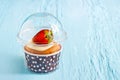 Strawberry cup cake on blue paint wooden background, soft and blur