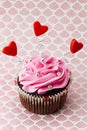 Strawberry cupcake with heart shapes and metal beads